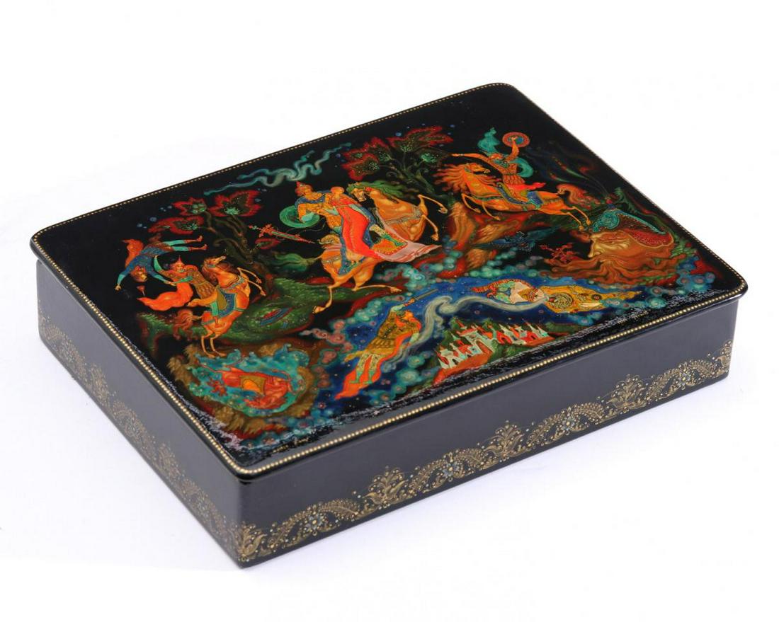 TWO LARGE 20TH CENTURY RUSSIAN LACQUER BOXES: The example depicting Ruslan and Ludmilla signed Sanalov. Plus a second larger box. Plus a second box depicting the Tale of Tzar Saltan, 1979.We happily provide seamless in-house packing and shipping
