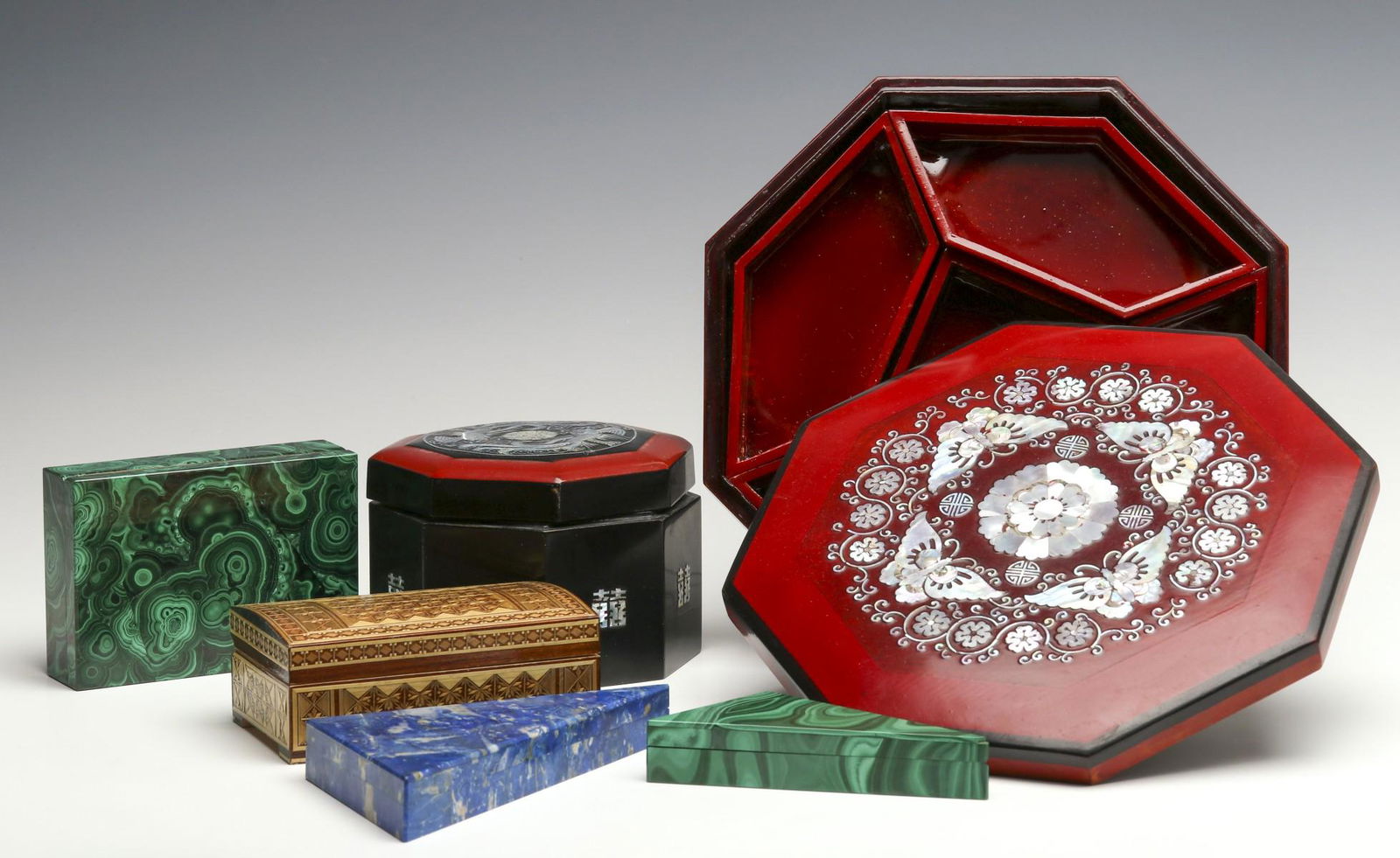 A COLLECTION OF DECORATIVE BOXES AND CONTAINERS: Including Italian examples with malachite and lapis veneers, lacquers with shell inlays, and one more with wood inlays.We happily provide seamless in-house packing and shipping services on nearly ever