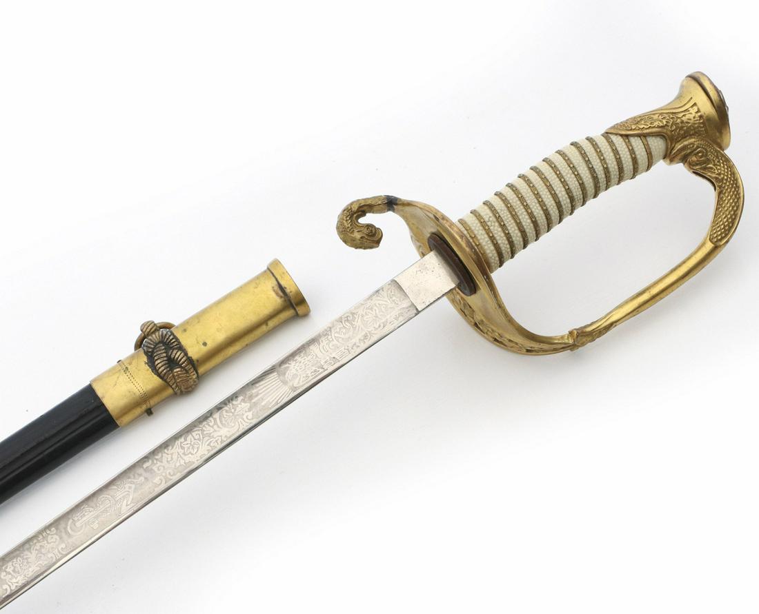 A US WORLD WAR TWO NAVAL DRESS OFFICER'S DRESS SWORD: The etched blade with with anchors, eagle, stars, U.S.N. and additional elaborate decoration, Star of David mark, attributed to Hilborn Hamburger from Soligen, Germany, scabbard with sailor's knots an