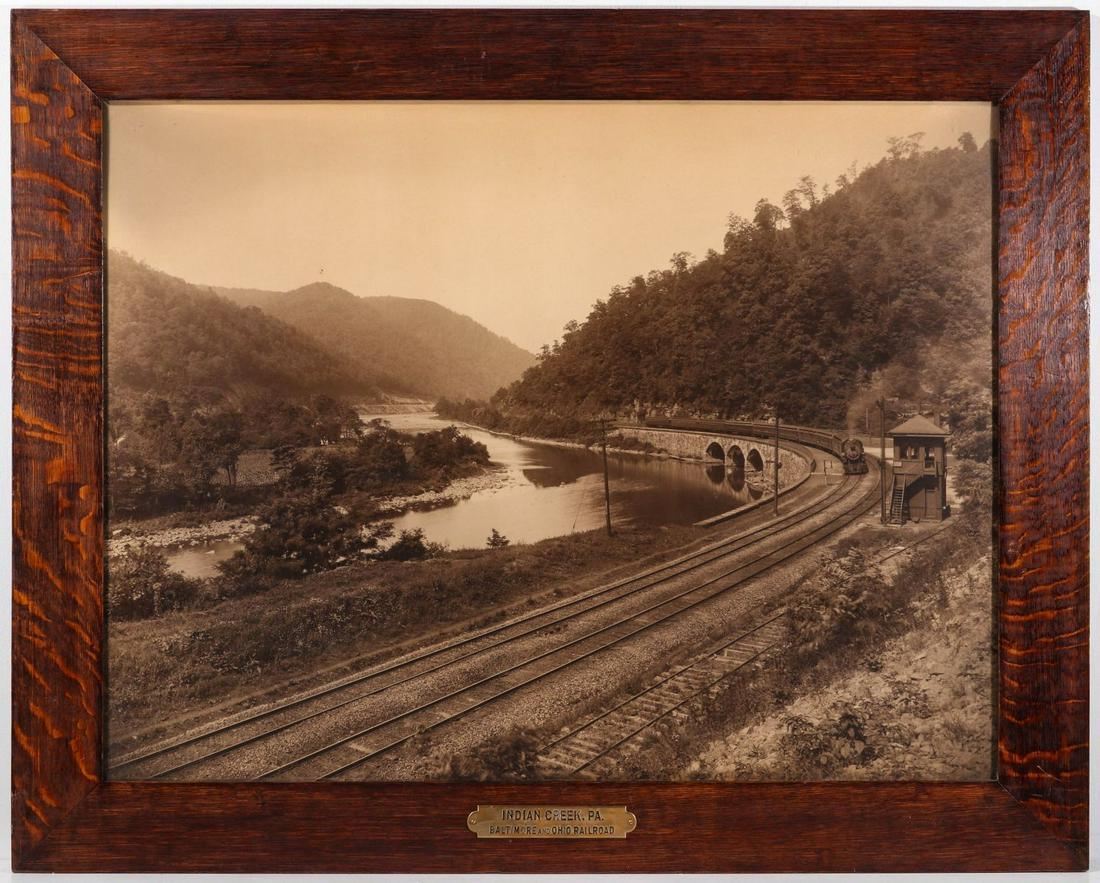 A PHOTOGRAVURE VIEW OF INDIAN CREEK PA ON THE B&O: The large sepia tone photomechanical image in quarter-sawn tiger oak frame with original period brass plaque identifying the scene as Indian Creek. PA. along the B&O in Pennsylvania, circa 19. Sig