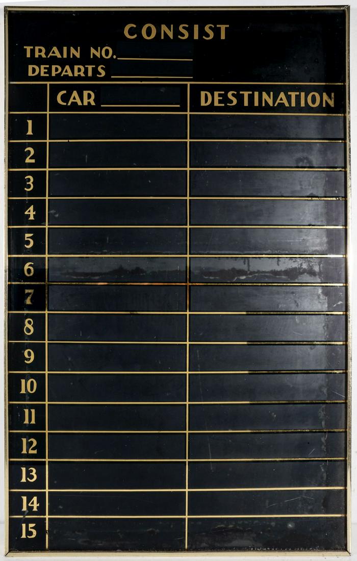 A REVERSE PAINTED GLASS TRAIN BULLETIN SCHEDULING BOARD: The gold numerals and scale painted in reverse on glass against black ground, circa 1930s. Measures 42 x 27.5 inches. We happily provide seamless in-house packing and shipping services on nearly every