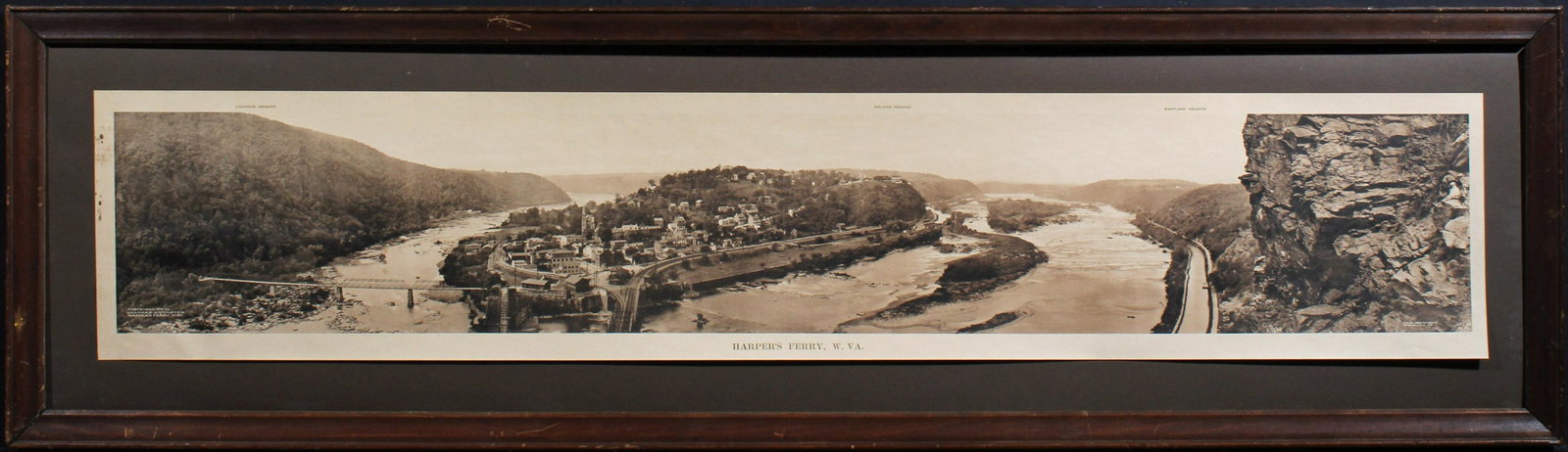 A PANORAMA PHOTOGRAPH OF HARPER'S FERRY CIRCA 1912: The yard-long photomechanical print titled 'Harper's Ferry, W. Va.' lower center, copyright date 1912, signed Walter E. Dittmeyer (1878-1937) lower left. Sheet measures 7 x 37 inches, the frame is 11.