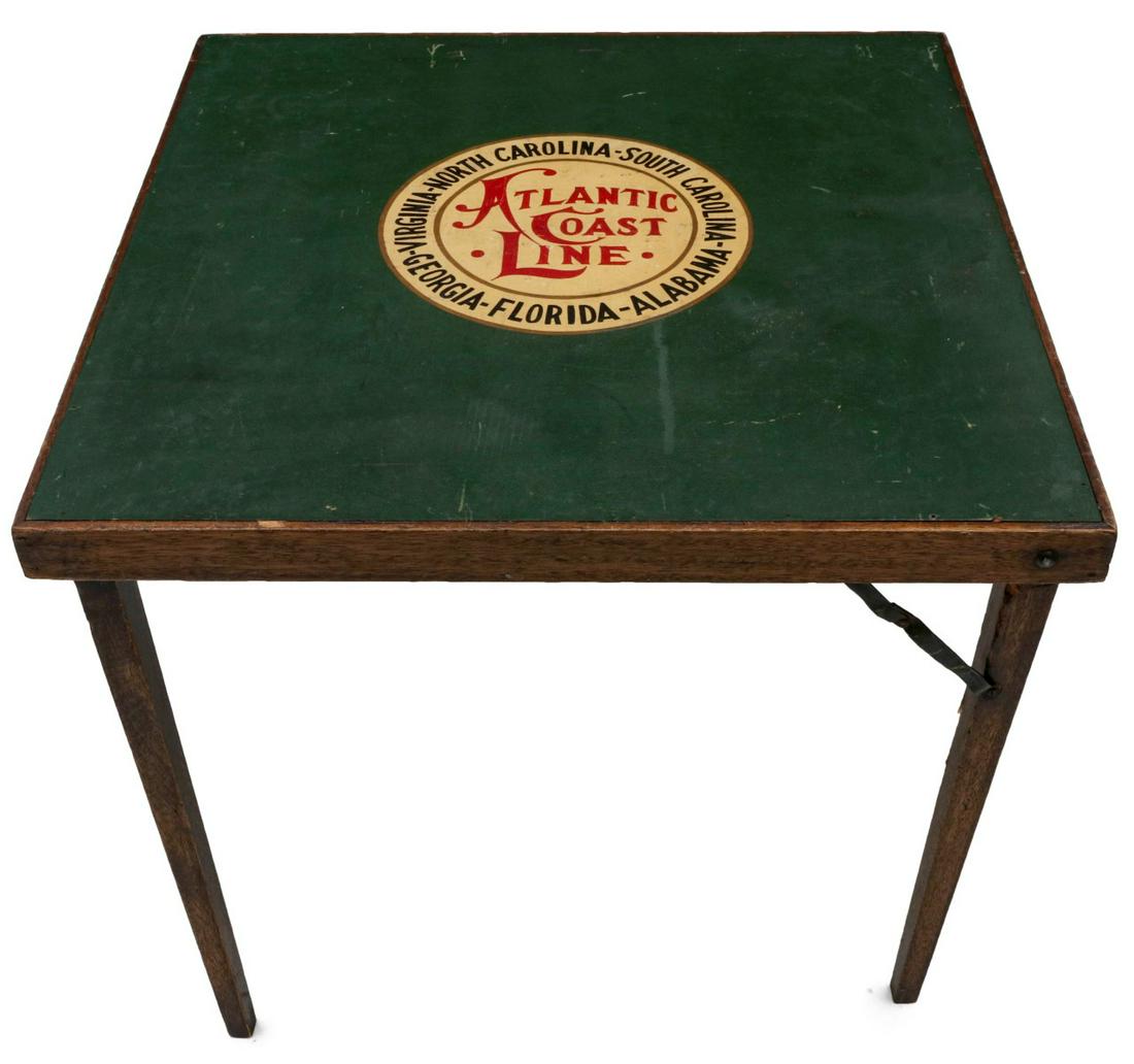 A CARD TABLE ADVERTISING ATLANTIC COAST LINE RR C. 1940: The walnut stain wood frame with green inset and four-color logo for the Atlantic Coast Line. Measures 30 x 30 inches. We happily provide seamless in-house packing and shipping services on nearly ever
