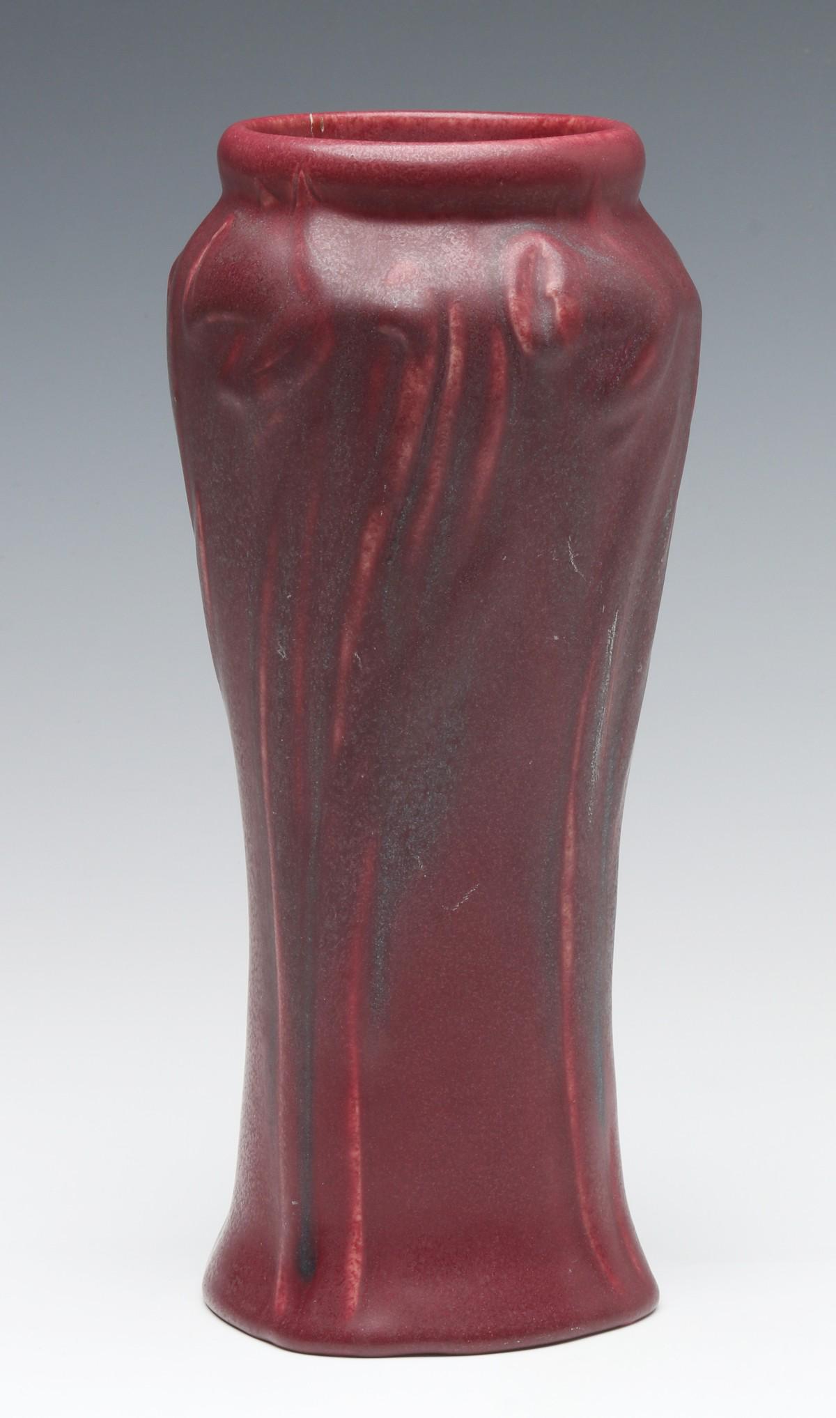 A 1920s VAN BRIGGLE MULBERRY GLAZE VASE WITH USA MARK: A Van Briggle vase in Mulberry glaze, USA mark on the base. Measures 9.25 x 4.25 inches. We happily provide seamless in-house packing and shipping services on nearly everything we sell.