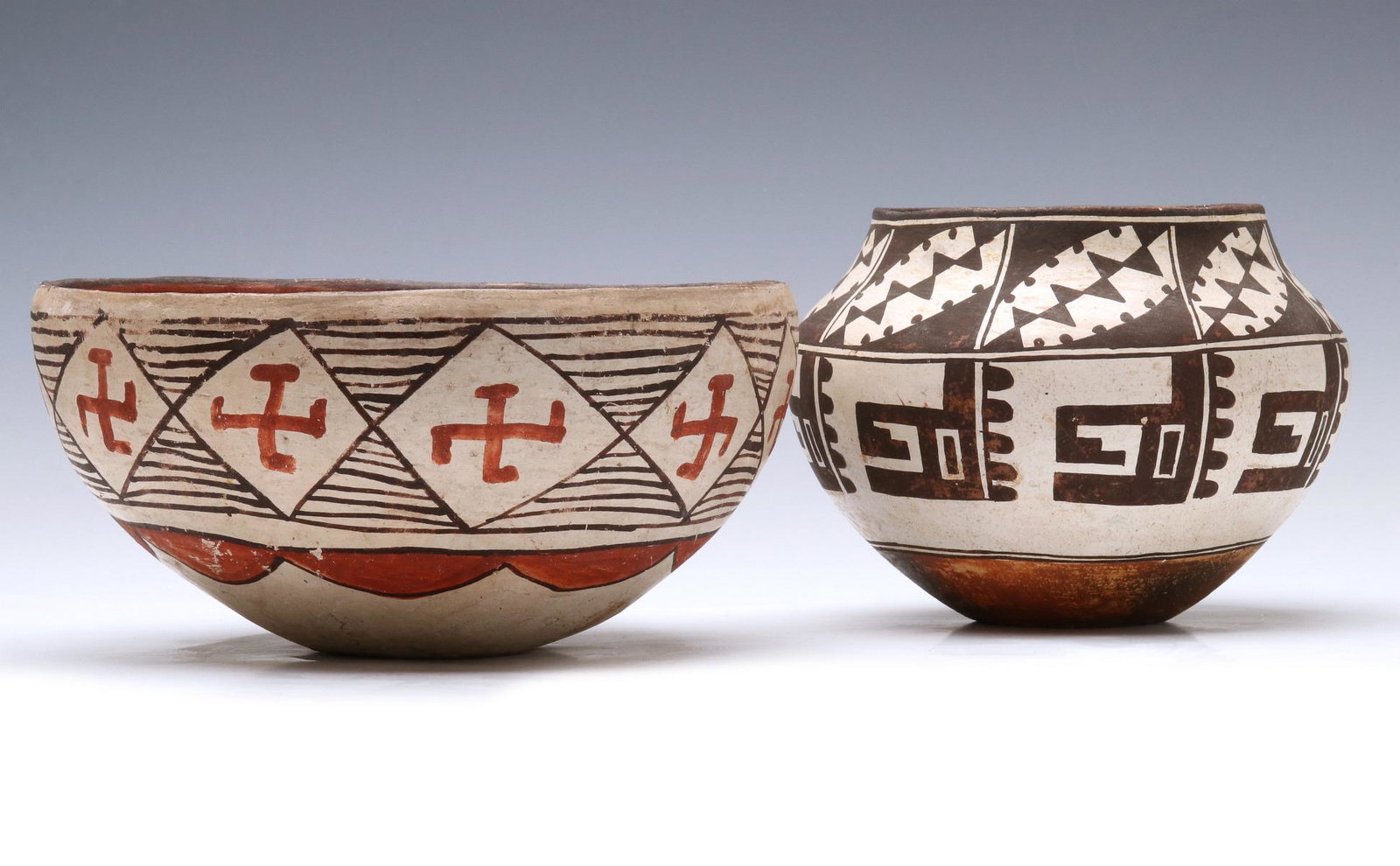 PAIRED ISLETA AND ACOMA POTTERY BOWL AND OLLA: The Isleta pueblo bowl with stylized whirling log pattern in diamonds against horizontal lines (crack), plus a nice Acoma pueblo olla signed Connie Garcia. Measure 5.25 x 7 and 4 x 8.5 inches. We happ