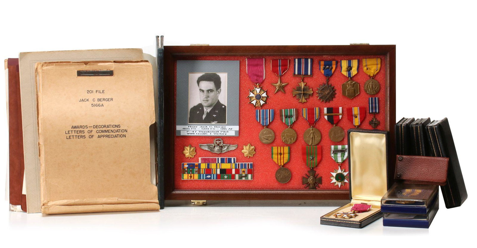MAJ BERGER GROUPING W/LEGION OF MERIT, DFC BRONZE STAR: Major Jack C. Berger, 509th FS, 9th Army Air Force. Shadow box containing: portrait photo; pair Major insignia; Master Pilot wings; 16 place ribbon bar; 9th AAF SSI; 9th AAF DI; Legion of Merit with c