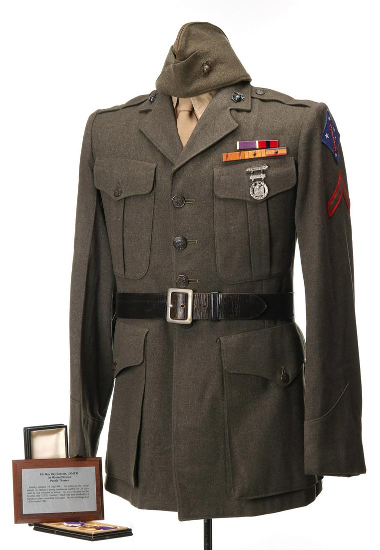 PFC. ROY RAY ROBERTS UNIFORM AND PURPLE HEART: Private First Class Roy Ray Roberts, USMC. Uniform consisting of tunic to include all insignia, five place ribbon bar, SMG Shooting Badge, block leather belt, shirt, tie, garrison cap, cased Purple He