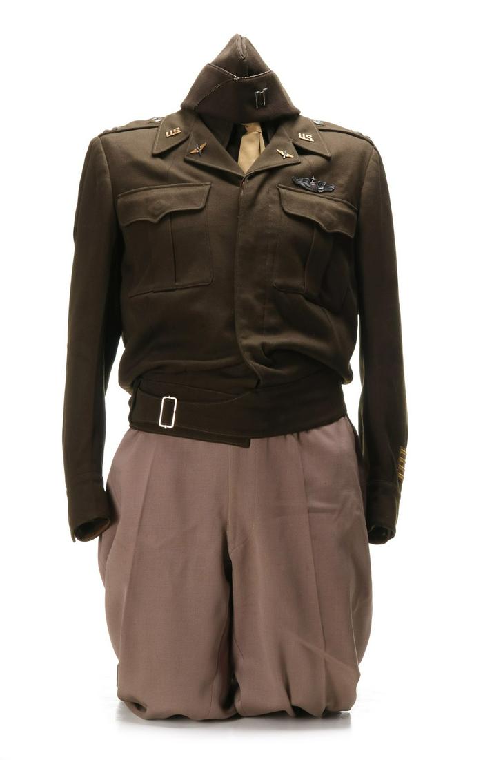 WWII IKE JACKET UNIFORM WITH SENIOR PILOT WINGS: Tailored Ike jacket with insignia Senior Pilot wings, shirt, tie, pants, garrison cap. Unidentified 9th AAF Captain. All veteran attributions and histories have been provided by the consignor and are 
