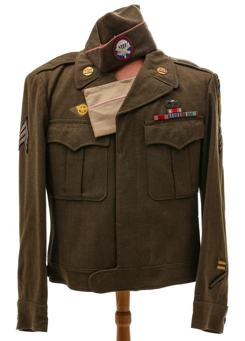 13TH AIRBORNE IKE JACKET W/ INSIGNIA, PARACHUTE BADGE: Unidentified 13th Airborne Ike jacket consisting of SSI, two collar disc insignia, rank stripes, two overseas bars, one longevity hash mark, four place ribbon bar, parachute badge, two overseas caps. 