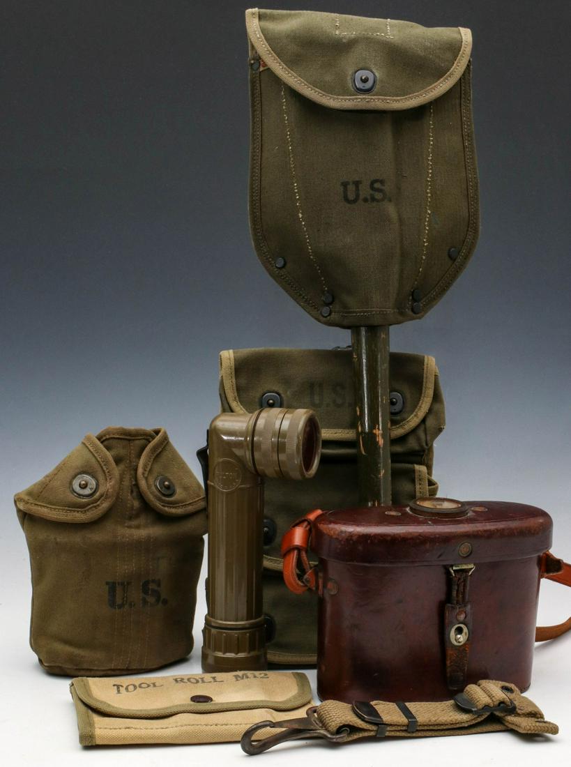 A COLLECTION OF US WWII FIELD GEAR: A collection of field gear including: Suspension strap for a canteen. Flashlight MX991/U. Entrenching tool dated 44 with cover. USA Stereo Prism binoculars with neck strap and case with compass on the
