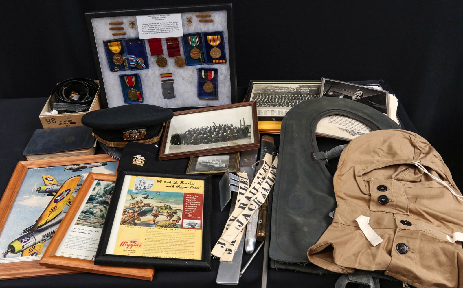 JOHN BENNYL USNR NEDAL GROUPING W/ PARACHUTE, VEST ETC: Riker mount grouping to John Bennyl USNR USS Laffey, both theatres, plus parachute rigger equipment with his name tags, PT boat life vest, boxed sword belt with hangers, two USMS head gear, assorted f