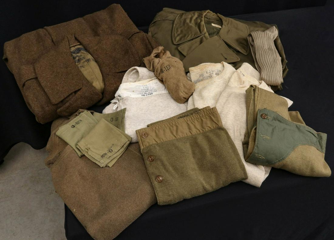 NAMED DUFFEL BAGS AND UNIFORM PIECES FROM ONE GI: Grouping belonging to M-1834 - Overcoat M-1942, Men's field overcoat as issued, OD wool drawers, OD wool drawers variation; OD wool socks, handkerchiefs. Grouping belonging to Lieutenant E.L. Shelton: