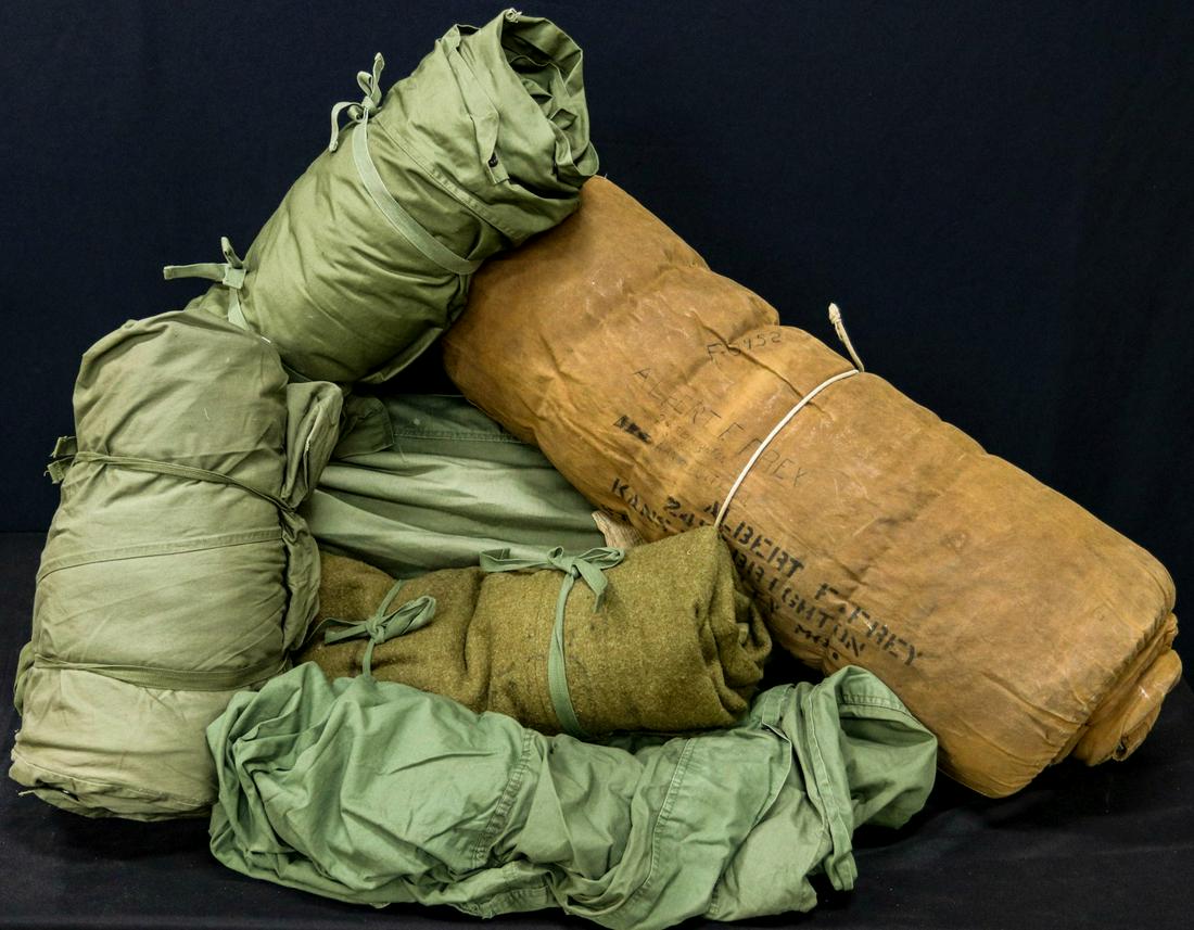 NAMED AND OTHER WWII SLEEPING BAGS: One named to Albert F. Frey, with cover; One named to private first class Julian S Douthal; Two M-1944 sleeping bags; Type a A-3 Army Air Force sleeping bag with outer cover and packing bag; Arctic sl