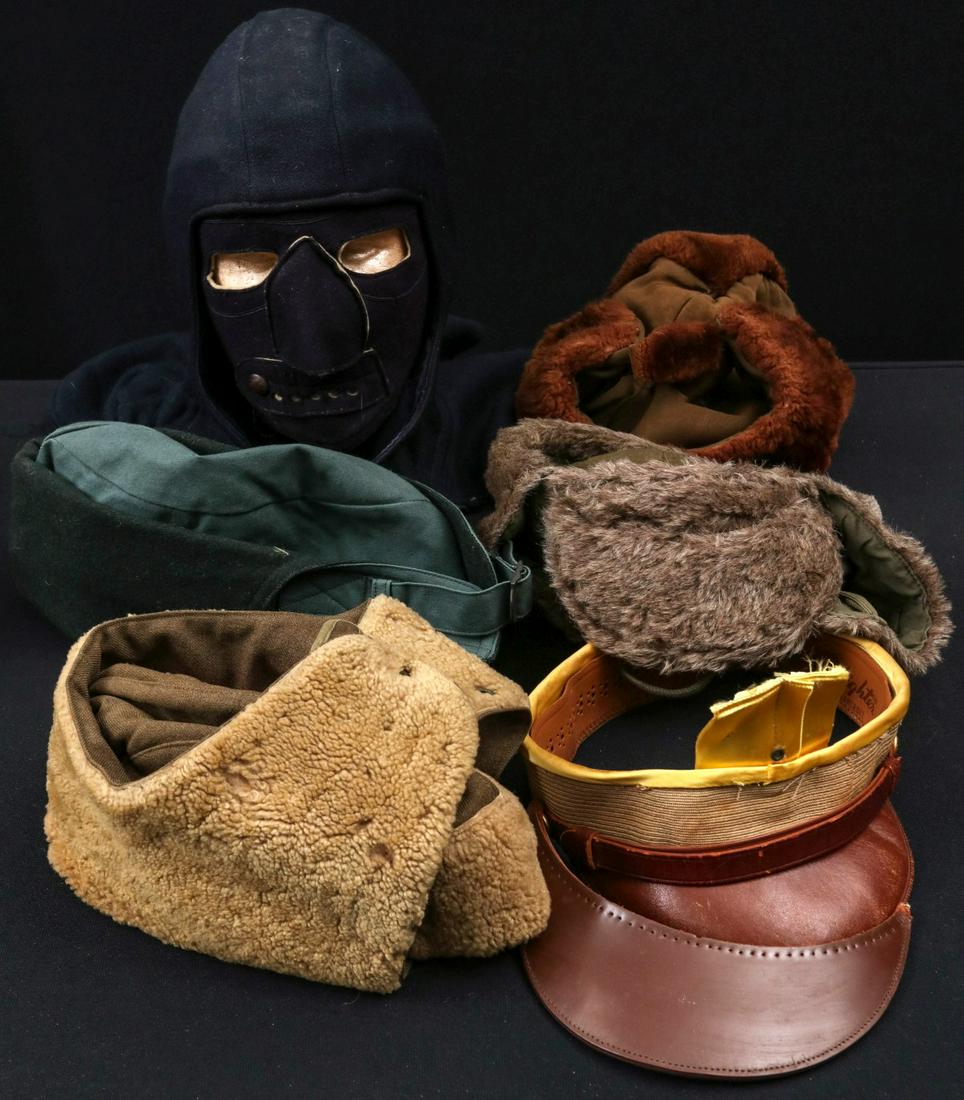 A COLLECTION OF WWII AVIATOR AND OTHER HEAD GEAR: A collection of headgear including: HBT M-1941 fatigue cap; lamb skin lined winter cap; aviator's cap B-9; 1943 olive drab pile cap with initial and last four; 1939 CCC winter cap; Navy cold weather f
