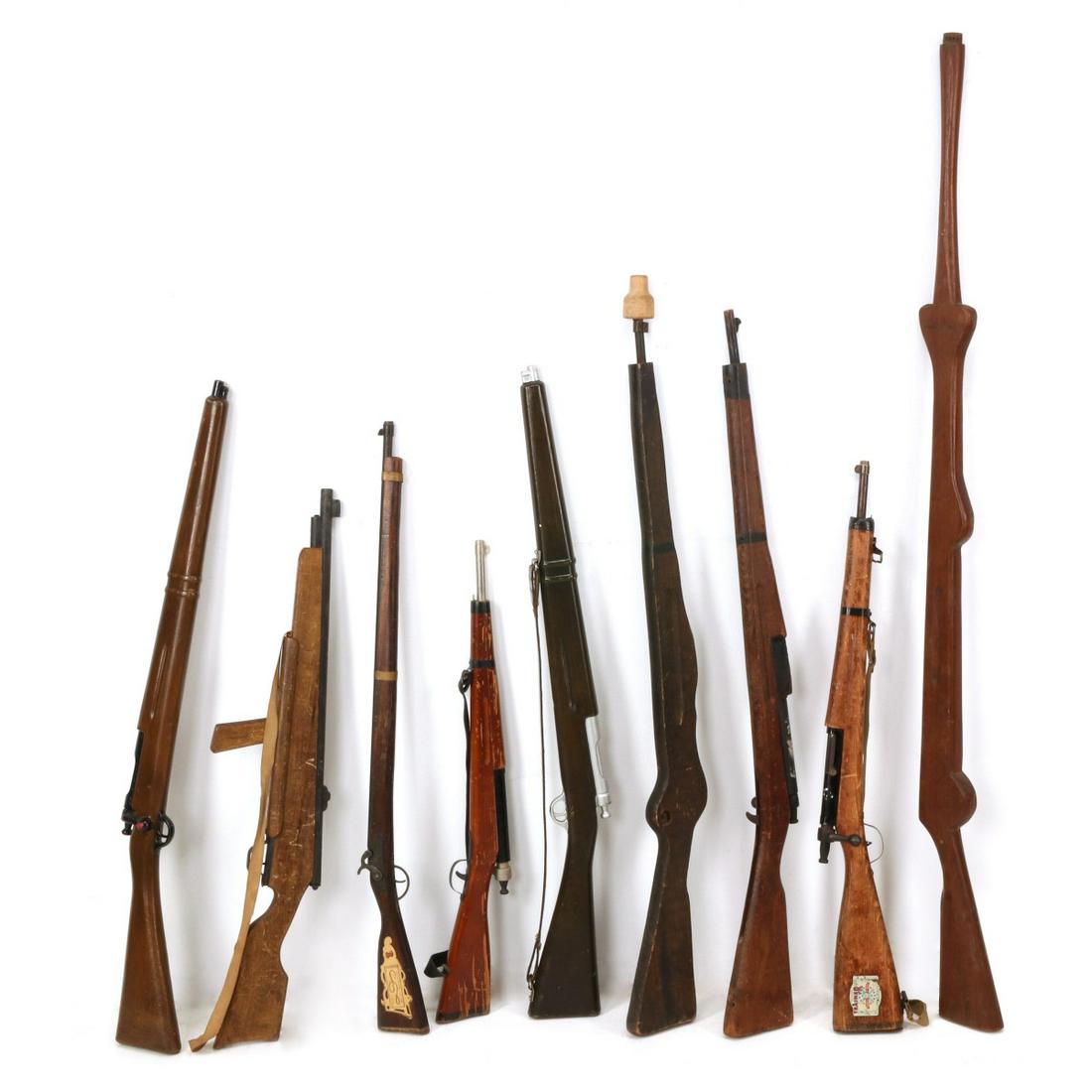 WOOD TRAINING RIFLES INCLUDING SUB-MACHINE GUN TRAINER: Training rifles, etc: Two parade rifles; Three training rifles; Training rifle with wooden bayonet; Flint lock toy; Two Parris training rifles; 1943 dated sub-machine gun trainer. We happily provide s
