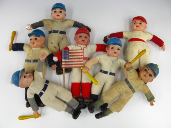 7 CELLULOID & CLOTH BASEBALL PLAYER DOLLS: Measurements of all 7.5 x 2 inches. These baseball dolls have celluloid heads, hands, and feet. Some have ball, gloves, and bats. Uniforms are made of different cloth. Varied condition from good to fa