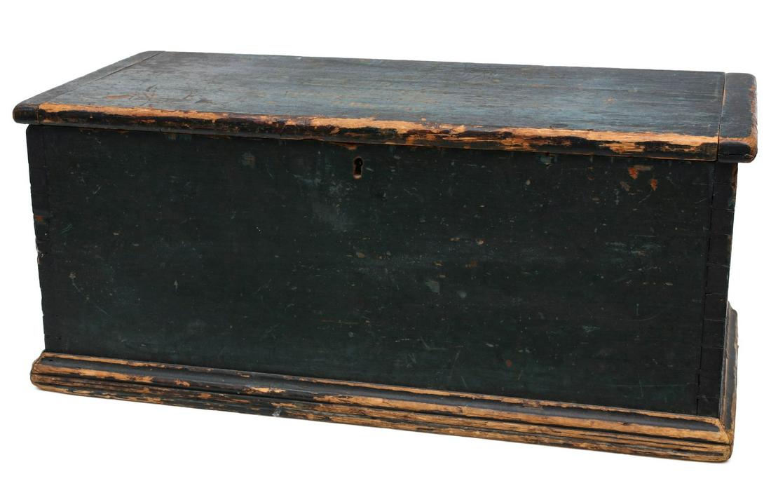 A 19TH C. SIX BOARD BLANKET CHEST IN OLD BLUE PAINT: The overhanging hinged lid with bread board ends above dovetailed case with molded base trim, original iron hinges and lock, original blue paint on pine. Measures 12.75 x 14 x 29.5 inches. Provenance: