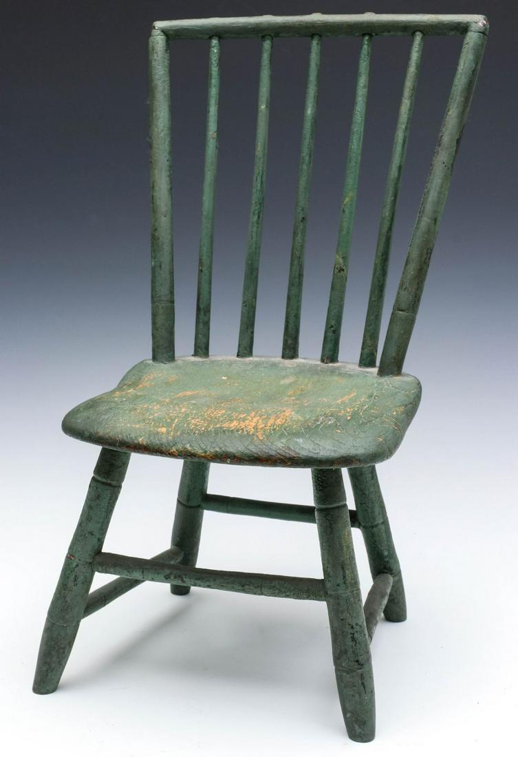 AN EARLY 19TH CENTURY WINDSOR BIRDCAGE CHILD'S CHAIR: The plank seat with birdcage style spindle back, turned 'faux bamboo' turned legs. Measures 20.75 x 12.5 x 11.75 inches. Provenance: The Jerry and Cathy Mueller Collection, Sioux City, Iowa We happily