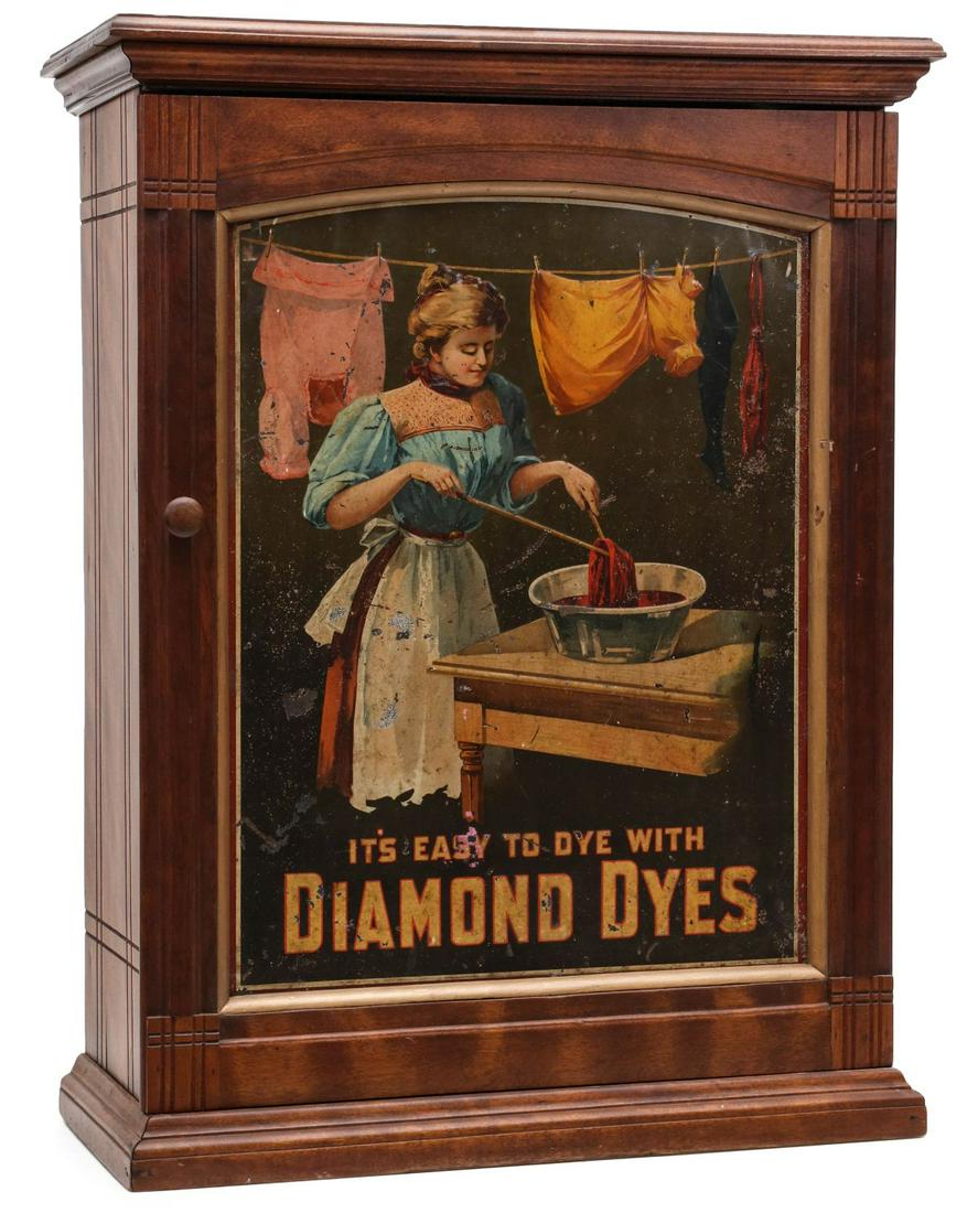 AN ORIGINAL DIAMOND DYES ADVERTISING MERCHANT'S CABINET: The maple cabinet with original lithographed tin advertising sign in the front door, sliding doors back side, no interior dividers. Measures 30 x 10 x 23 inches. Provenance: The Jerry and Cathy Muelle