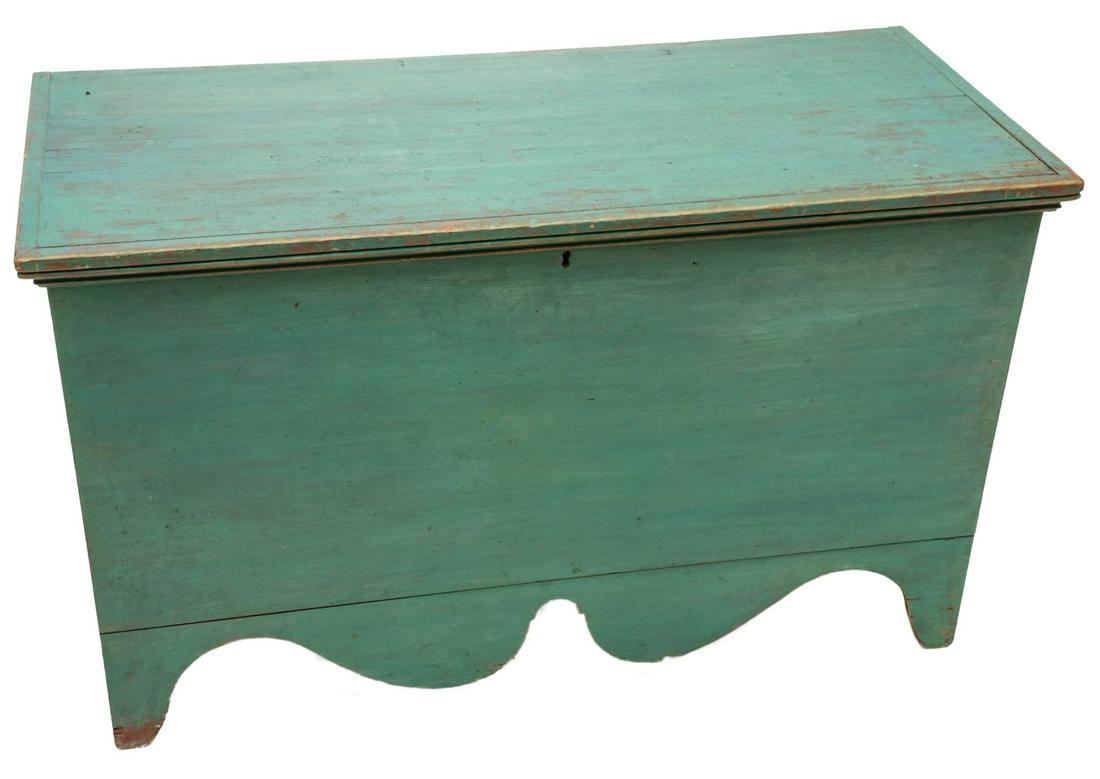 AN EARLY 19TH C. NEW ENGLAND PAINTED BLANKET CHEST: The six board chest with rectangular lid framed in grooved molding over a square-nailed case on base with exuberant scroll-cut skirt and squared corner feet either side of the graceful end cut-outs, o