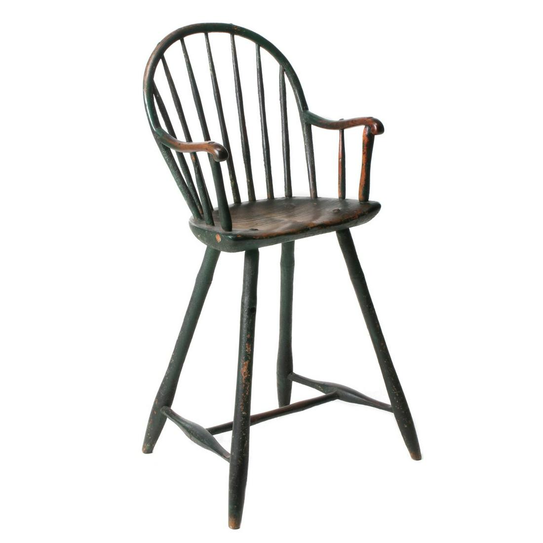 AN 18TH C. BOWBACK WINDSOR YOUTH CHAIR IN OLD PAINT: The seven-spindle bowback youth chair with ash arms and bamboo turnings, shaped pine seat, great old crusty painted green surface, Philadelphia circa 1790. Measures 36 x 16.5 x 14 inches. Provenance: 