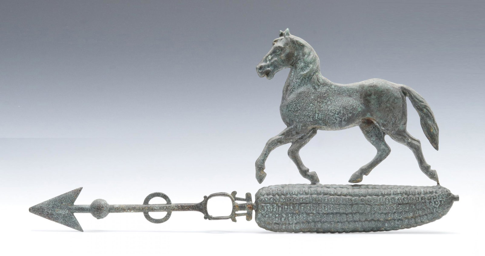 A LIGHTNING ROD WEATHER VANE WITH HORSE ON EAR OF CORN: The full-bodied zinc horse atop molded full-body ear of corn mounted on fancy iron directional. Measures 13 x 25 x 1.25 inches. Provenance: The Jerry and Cathy Mueller Collection, Sioux City, Iowa We 