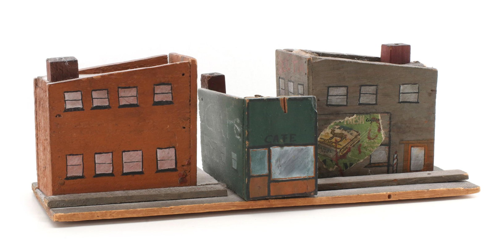 A SIX-PIECE FOLK ART TOWN MODEL FROM FOUND MATERIALS: The structures and settings and, in some cases, architecture of a typical Midwestern town at the turn of the last century, each primitive depiction constructed from found crating materials and painted