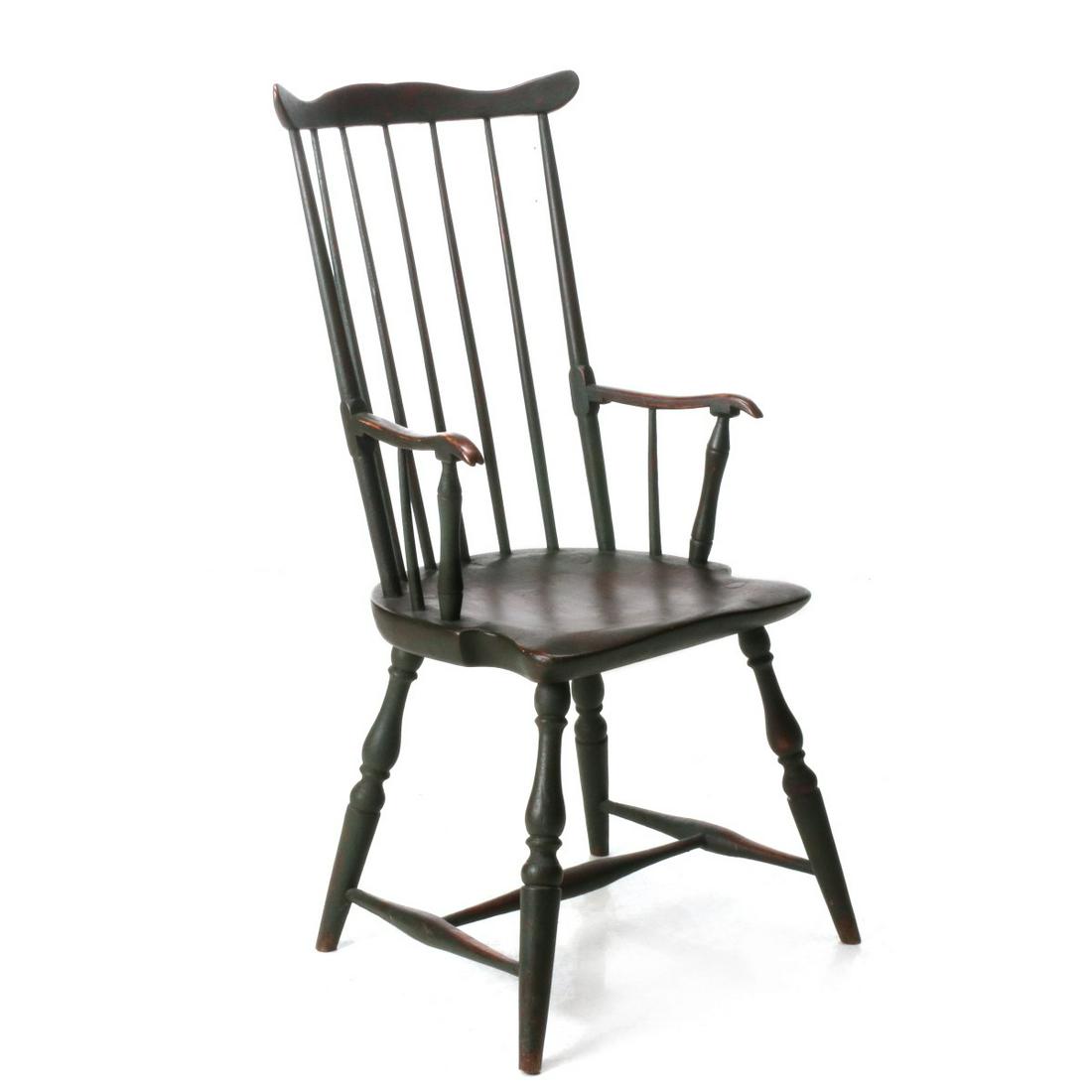 AN 18TH C. FAN BACK WINDSOR CHAIR IN OLD GREEN PAINT: The unusual New England fan back variation with shaped ash crest upon spindle back and outside posts carved with integral square block joining a delicate arm having unusual knuckle supported by faux b