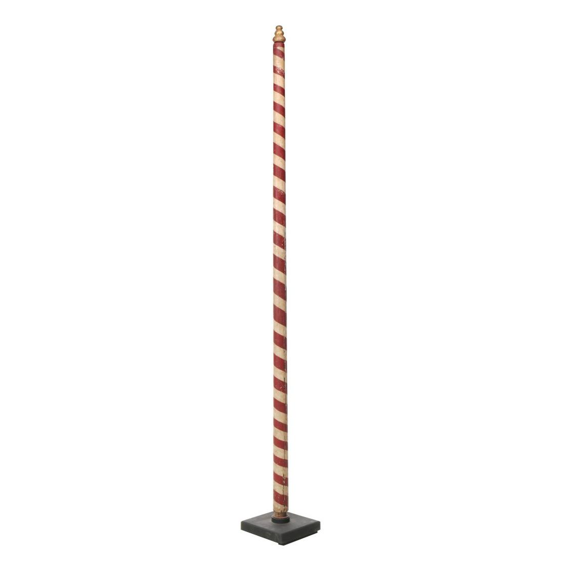 AN UPRIGHT 19TH CENTURY PAINTED WOOD BARBER POLE: The turned wood pole in old cast iron mount, traditional red and white ribbon stripe in old paint, turned finial topper in gold. Measures 81 x 9 x 9 inches. Provenance: The Jerry and Cathy Mueller Col