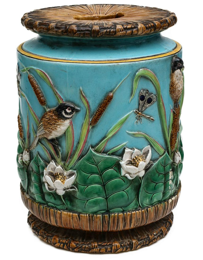 A COLORFUL GEORGE JONES MAJOLICA GARDEN SEAT CIRCA 1875: The top with openwork hand hold and molded basket weave motif over turquoise cylindrical form decorated by molded birds, insects, water lilies and bulrushes in relief above the molded basket weave bas