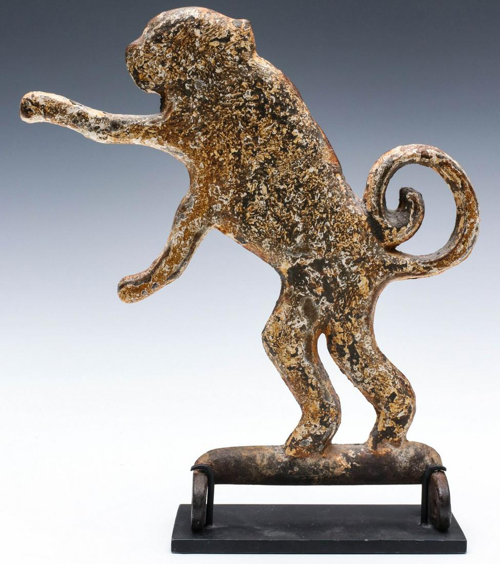 A RARE FOLK ART IRON MONKEY SHOOTING GALLERY TARGET: The cast iron depiction of a long-tailed monkey posed in an animated upright stance with outstanding surface of old iron and old paint shot-peened for years by lead pellets to create the rare and inte