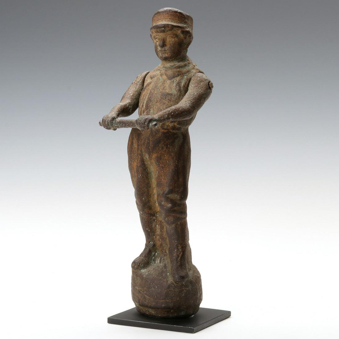 A GOOD 19TH CENTURY CAST IRON FIGURAL JOCKEY HITCHING: The original 19th century cast iron figure of a jockey in silks with boots and traditional cap, his hands joining a crossbar on outstretched arms hinged to provide a reticulated apparatus with which t