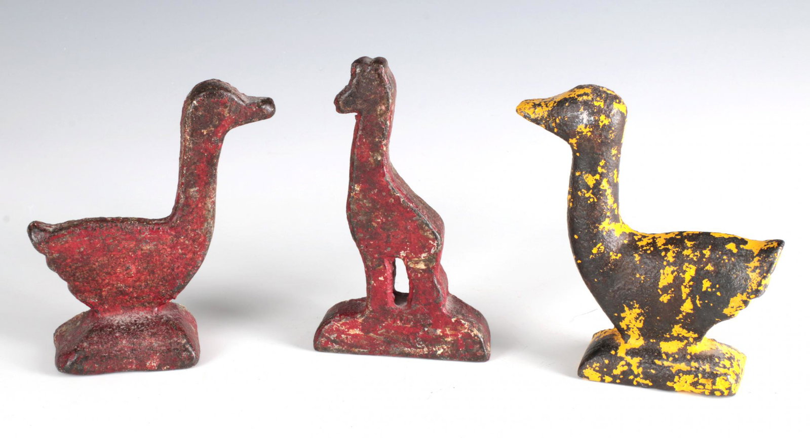 GIRAFFE AND GOOSE SHOOTING GALLERY TARGETS CIRCA 1900: Three early 20th century figural cast iron shooting gallery targets: two different goose figures and the figure of a giraffe, simple one-piece castings known as knock-down targets made by H.C. Evans, 