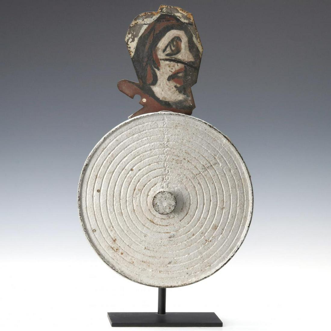 A WURFFLEIN ANIMATED SHOOTING GALLERY TARGET CIRCA 1910: The cast bullseye with pop-up character and numbered concentric rings with central button made by William Wurfflein, Philadelphia. A successful shot would ring a bell and release the pop-up painted sh