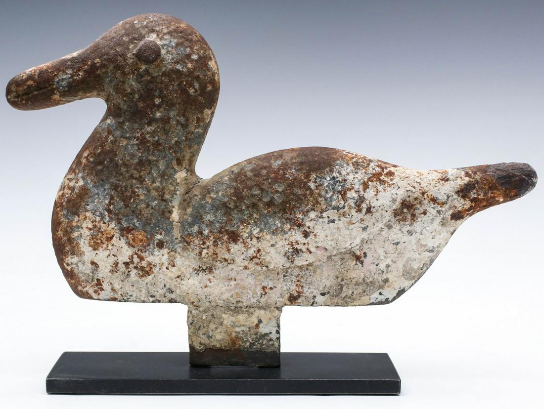 A FOLK LONG-BILLED DUCK SHOOTING GALLERY TARGET C. 1920: The classic shooting gallery form in charming proportions with primitive eye, bill and wing detail shot-peened overall for an interesting golf ball-like surface with remnant dry old park paint. Pictur