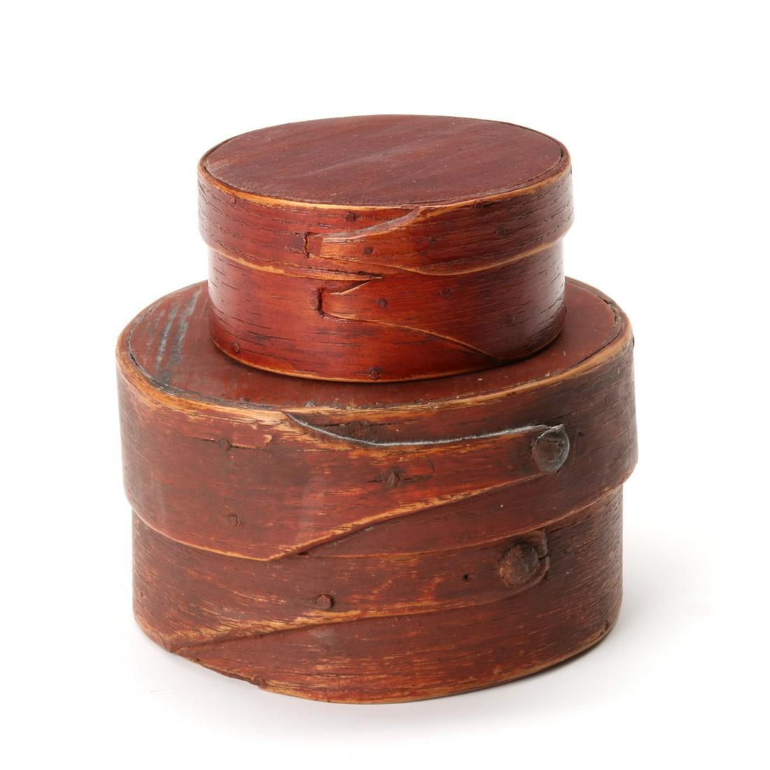 TWO 19TH C. PANTRY BOXES WITH INTERESTING FINGER LAPS: The two circular boxes in old red stain, the smaller constructed with wood pegs and unusual button hole laced technique. The larger bentwood box with wide bands and long narrow finger laps constructed