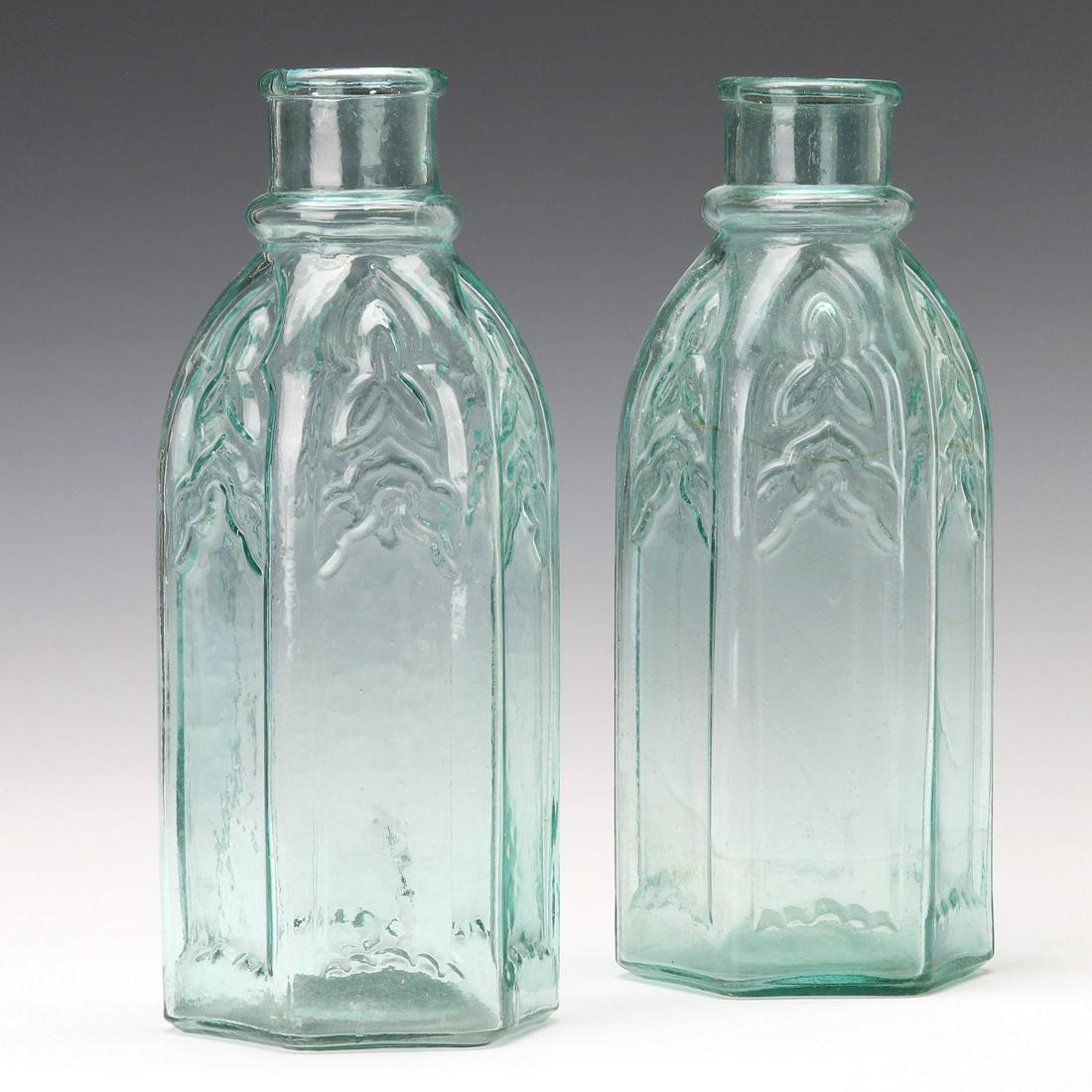 TWO EARLY AMERICAN GOTHIC ARCH CATHEDRAL PICKLE JARS: Near identical examples in aqua glass, one with an interesting thin line of orange color running through one, circa 1870. Each measures 13.5 x 5.5 inches. We happily provide seamless in-house packing 