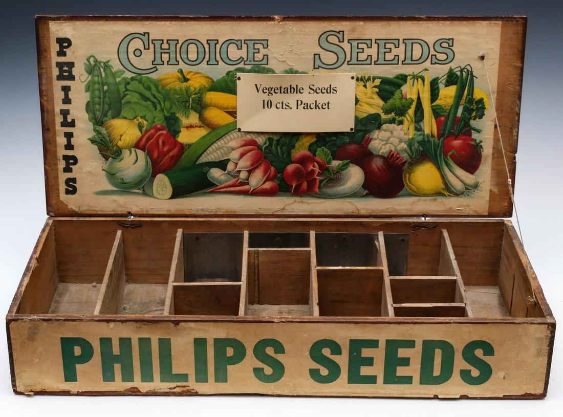 A COUNTRY STORE DISPLAY BOX FOR PHILLIPS CHOICE SEEDS: The dovetailed seed pack box with brightly colored chromolithography on paper inside the lid, divided interior, simple wire hinges, graphics on the exterior, circa 1875. Measures 4.75 x 25.5 x 11 inch