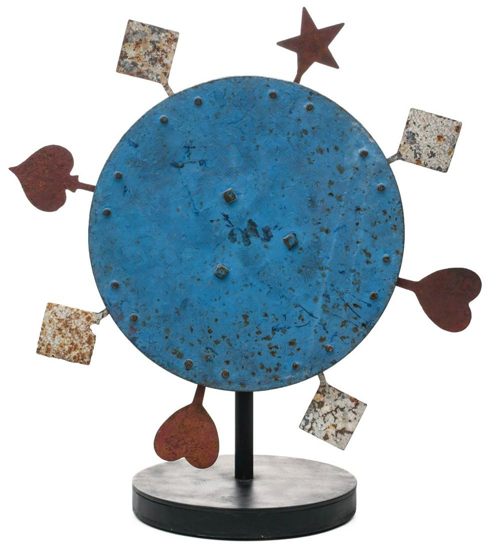 A SPINNING IRON TARGET WITH PLAYING CARD SUITS C. 1900: An unusual configuration of star, spade, heart and diamond form hinged iron knockdown targets in old red and white park paint on blue disc manufactured by William F. Mangels Company, Coney Island, NY.