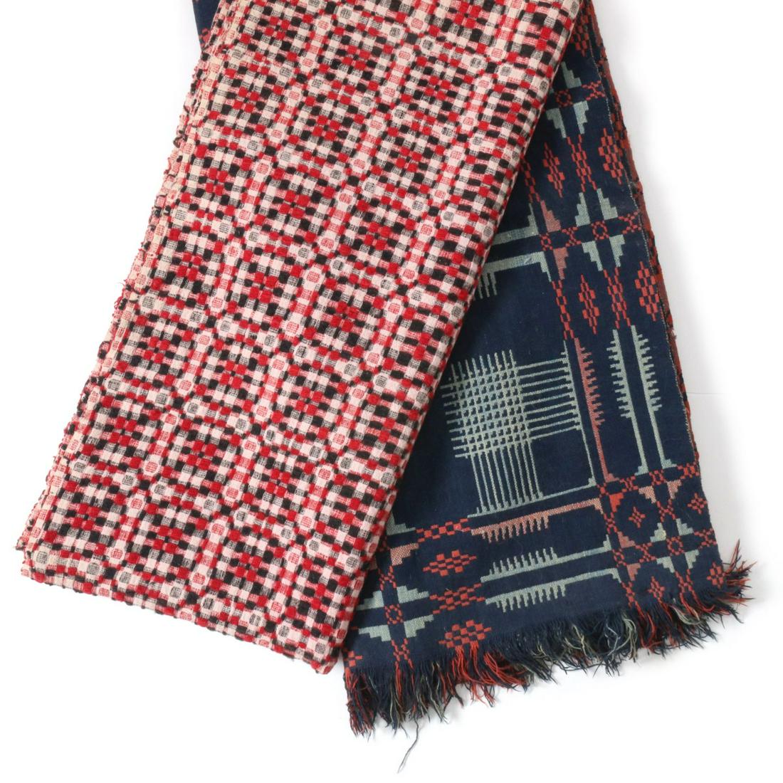TWO ANTIQUE RED, WHITE AND BLUE COVERLETS: Th red, white and blue overshot coverlet paired with a Jacquard type red, light blue and blue coverlet, each woven in panels and joined by a central seam. Measure 90 x 73 and 73 x 62 inches. We happil