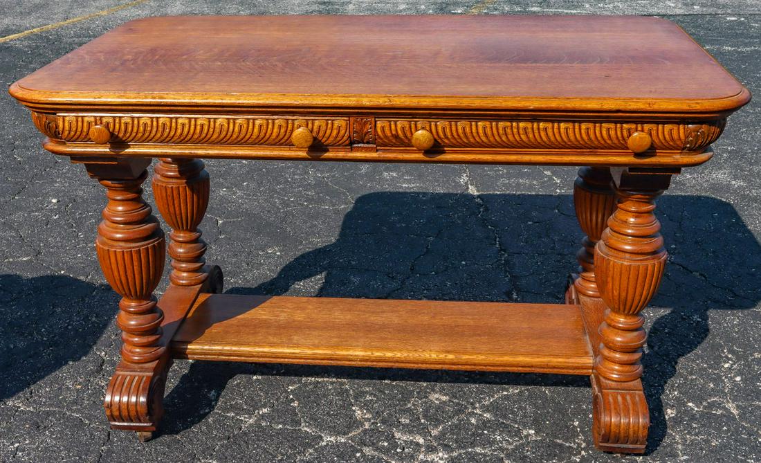 AN EARLY 20TH CENTURY CARVED GOLDEN OAK LIBRARY TABLE (1 of 7)