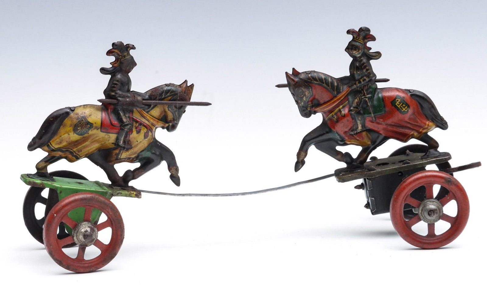 A GERMAN TIN LITHO JOUSTING KNIGHTS BACK-FORTH TOY: The lithographed tin figures do battle powered by the wind-up action. Measures 4.5 x 9.5 x 3 inches. We happily provide seamless in-house packing and shipping services on nearly everything we sell.