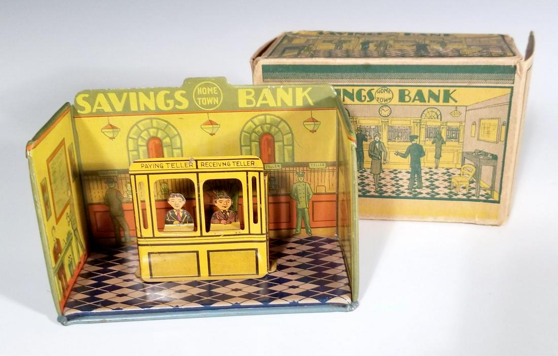 MARX 'HOMETOWN' TIN LITHO SAVINGS BANK PLAYSET WITH BOX: Circa 1920s, a colorful tin litho toy room titled 'Savings Bank' with its Paying and Receiving Teller accessory, includes the original printed cardboard box. Measures 3 x 5 x 2.5 inches. We happily pr