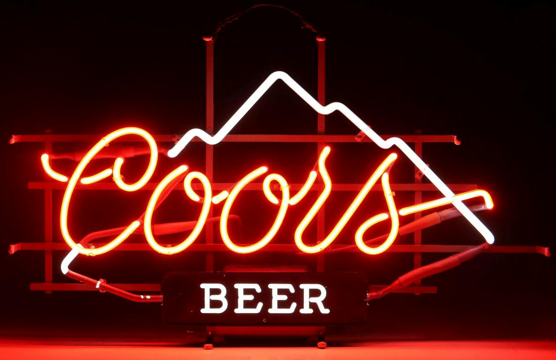 A COORS BEER NEON ADVERTISING SIGN: The two-color neon sign with the script Coors logo and mountains, mounted over an illuminated sign reading 'Beer,' signed Mt. Vernon Neon Sign Company, dated 1984 with a metal ID plate. Measures 16.5