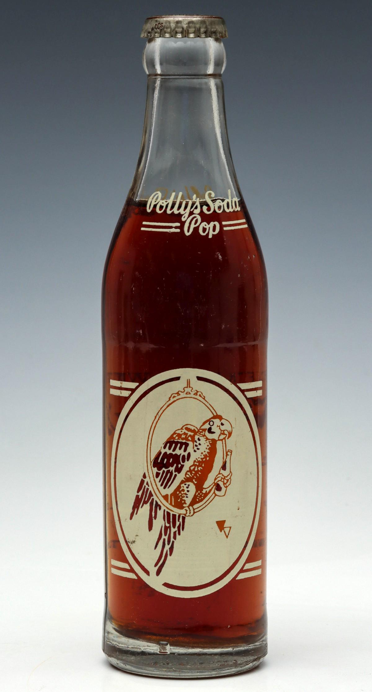 A RARE POLLY'S POP SODA BOTTLE WITH BROWN ACL GRAPHICS: Of the many color combinations found for the various sodas offered by the original Poll's Pop of Independence, Missouri (1923 - 1967), the brown color combinations on Polly the Parrot is the rarest by