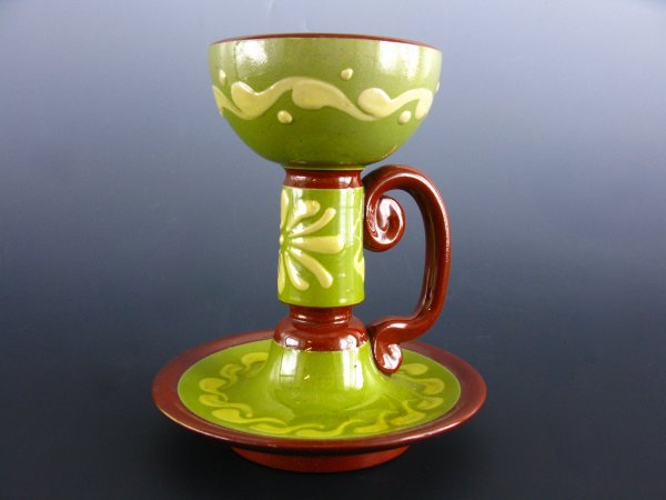 A TORQUAY CANDLESTICK HOLDER: Glazed green and brown porcelain candlestick holder, stem with handle. Marked base. Stands 5 1/2 inches.