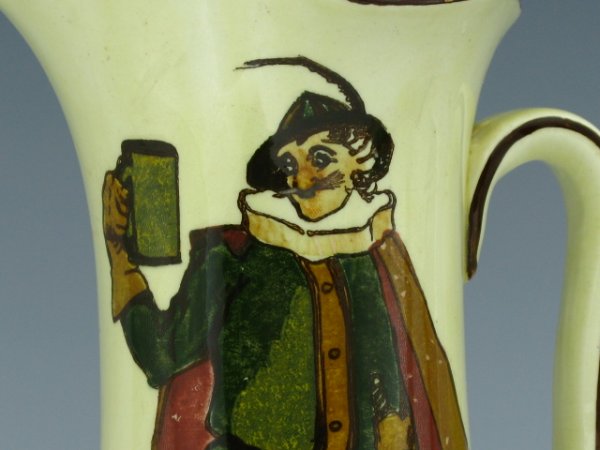 A ROYAL DOULTON SIR TOBY BELGH PITCHER: Royal Doulton maker marked bottom, cream colored with brown image. Stands 8 1/2" tall.