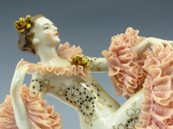 MULLER & CO GERMANY DANCING GIRL PORCELAIN FIGURINE: Pink ruffled dress, hand painted details including gold painted ballet slippers. Maker marked bottom. 8 inches