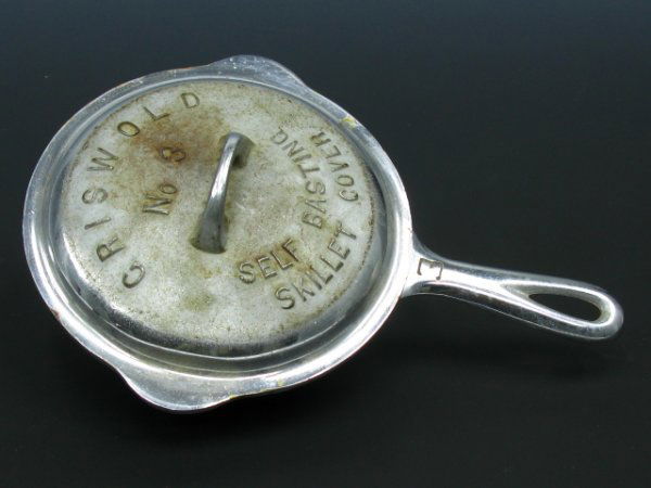 A GRISWOLD NO. 3 SKILLET WITH SELF-BASTING COVER: Very well marked, to bottom, embossed lettering on cover.