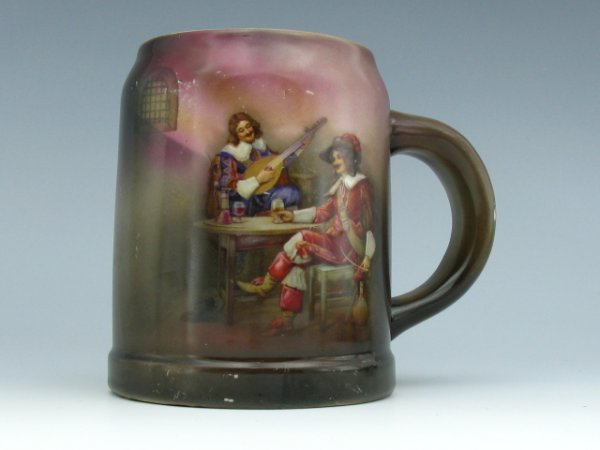 A ROYAL BAYREUTH 1/2 L BEER STEIN: Full color image of an early 17th century musician serenading a man seated with his drink in a pub. RB mark to bottom. Measures 5 x 4 inches.